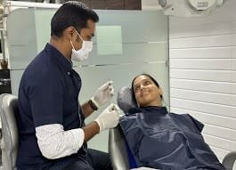 A dentist at work treating a patient at O Dental